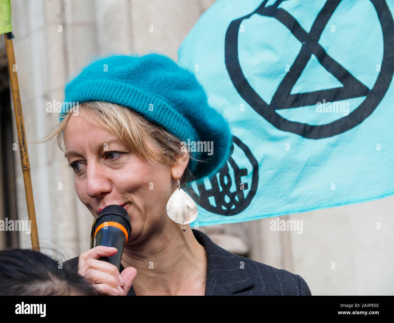 London, UK. 9th October 2019. Gail Bradbrook, co-founder of Extinction Rebellion speaks. As a part of Extinction Rebellion’s International Rebellion, Lawyers for XR read a declaration of rebellion against a legal system which is failing in its ultimate purpose of protecting and enriching life. They call for deep and urgent changes in our legal system to deal with climate justice and ecological collapse and provide true justice for all. Credit: Peter Marshall/Alamy Live News Stock Photo