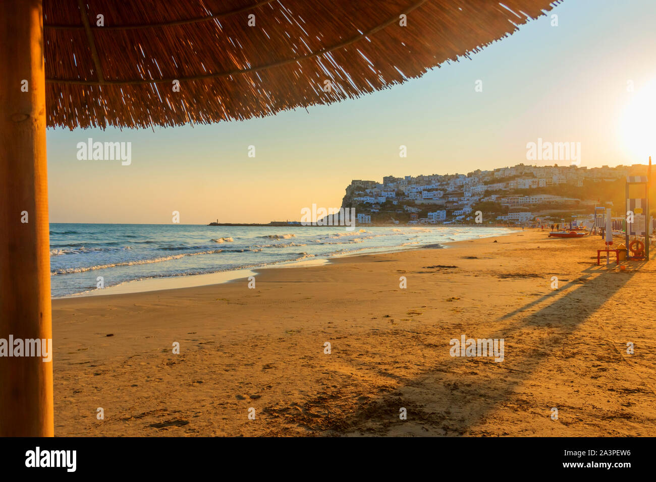 Bay of Peschici at sunrise: view of old town and sandy beach, Italy (Apulia). It's famous for its seaside resorts belongs to  Gargano Promontory. Stock Photo