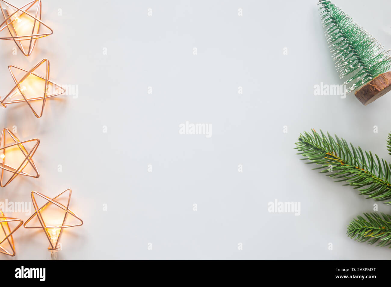 Holiday Christmas card background with festive decoration ball, stars, snowflakes, gift box, pine cones on a white background from Flat lay, top view. Stock Photo