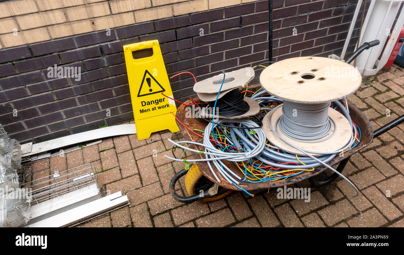 Offcuts of scrap electrical cable in a wheelbarrow on a construction
