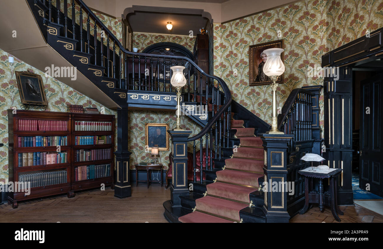 Staircase at The Ace of Clubs House in Texarkana, Texas, more formally known as the Draughon-Moore home. The house was built in 1885 in roughly the shape of the club figure on the ace of clubs card in a poker deck, with three octagonal wings and a rectangular wing. According to legend, the house was built with money won from a poker game. It is now a city-owned tour home and museum Stock Photo