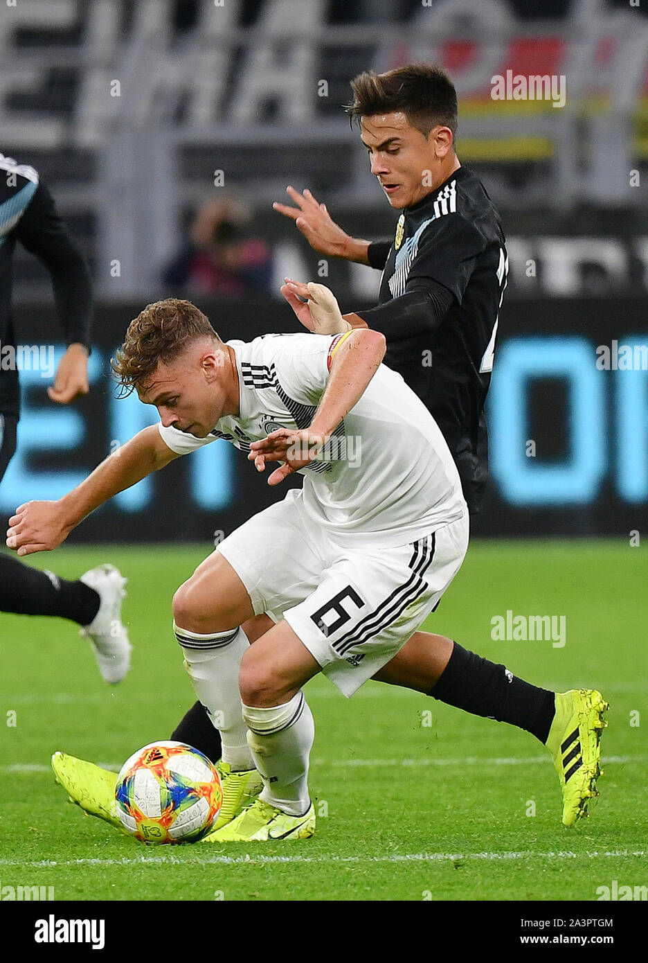 Dortmund, Germany. 9th Oct, 2019. Joshua Kimmich (front) of Germany vies with Paulo Dybala of Argentina during an international friendly soccer match between Germany and Argentina in Dortmund, Germany, Oct. 9, 2019. Credit: Ulrich Hufnagel/Xinhua/Alamy Live News Stock Photo