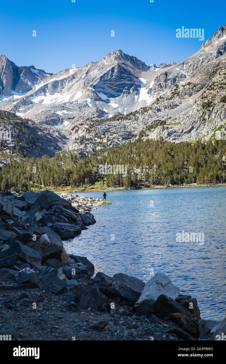 Fisherman fishing at Long Lake in Little Lakes Valley Eastern Sierra