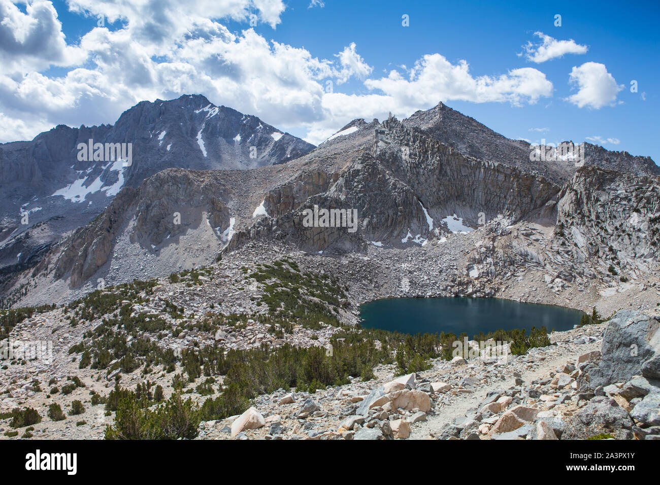 'Big pothole lake' with University Peak in the background and a unknown mountain pyramid on the  'Kearsarge Pass Trail' in the Sierra Nevada mountains Stock Photo