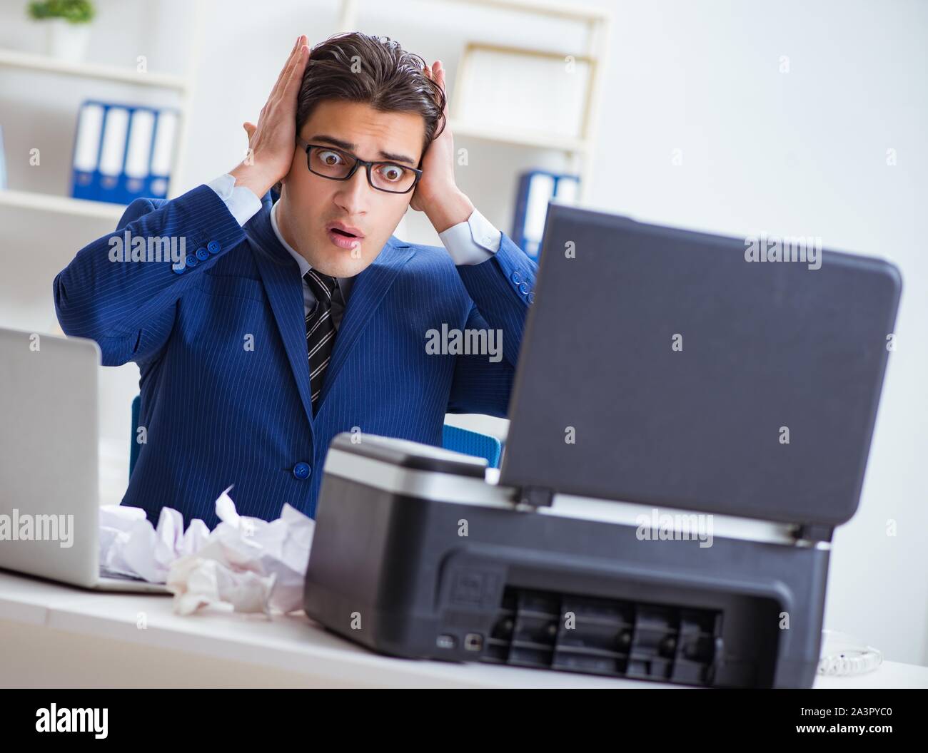 The businessman angry at copying machine jamming papers Stock Photo - Alamy