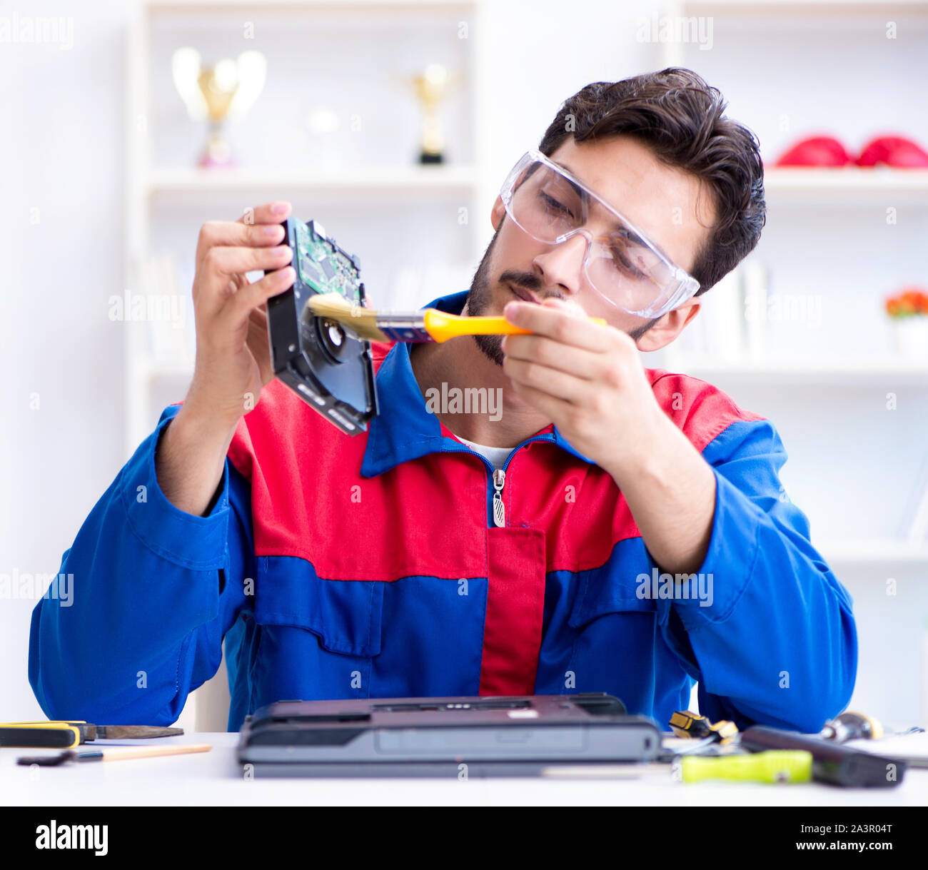 Repairman working in technical support fixing computer laptop troubleshooting Stock Photo