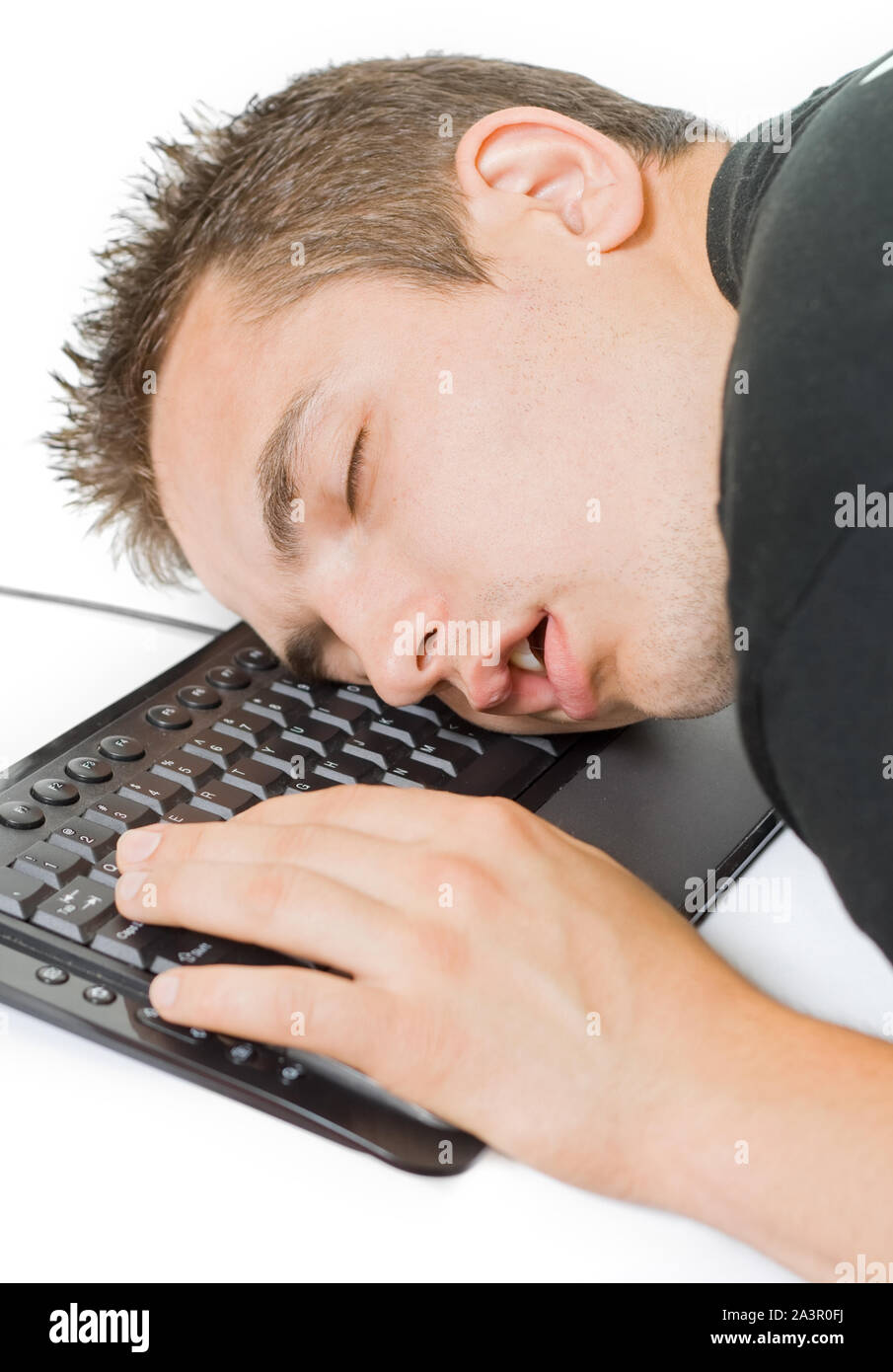Young tired man sleeping on the keyboard Stock Photo - Alamy