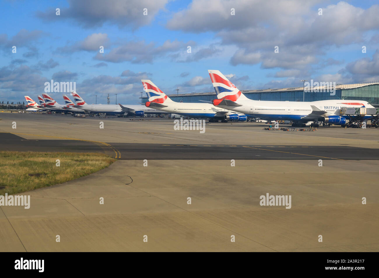 A Row Of British Airways Passenger Aircraft Parked At The Gates Of ...