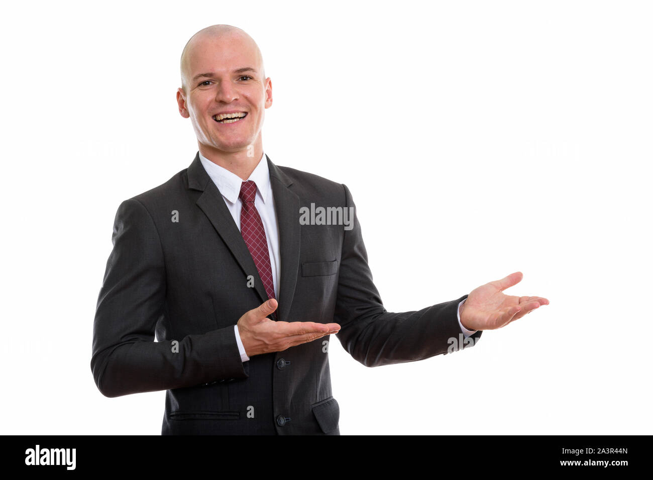 Happy handsome bald businessman presenting hi-res stock photography and ...
