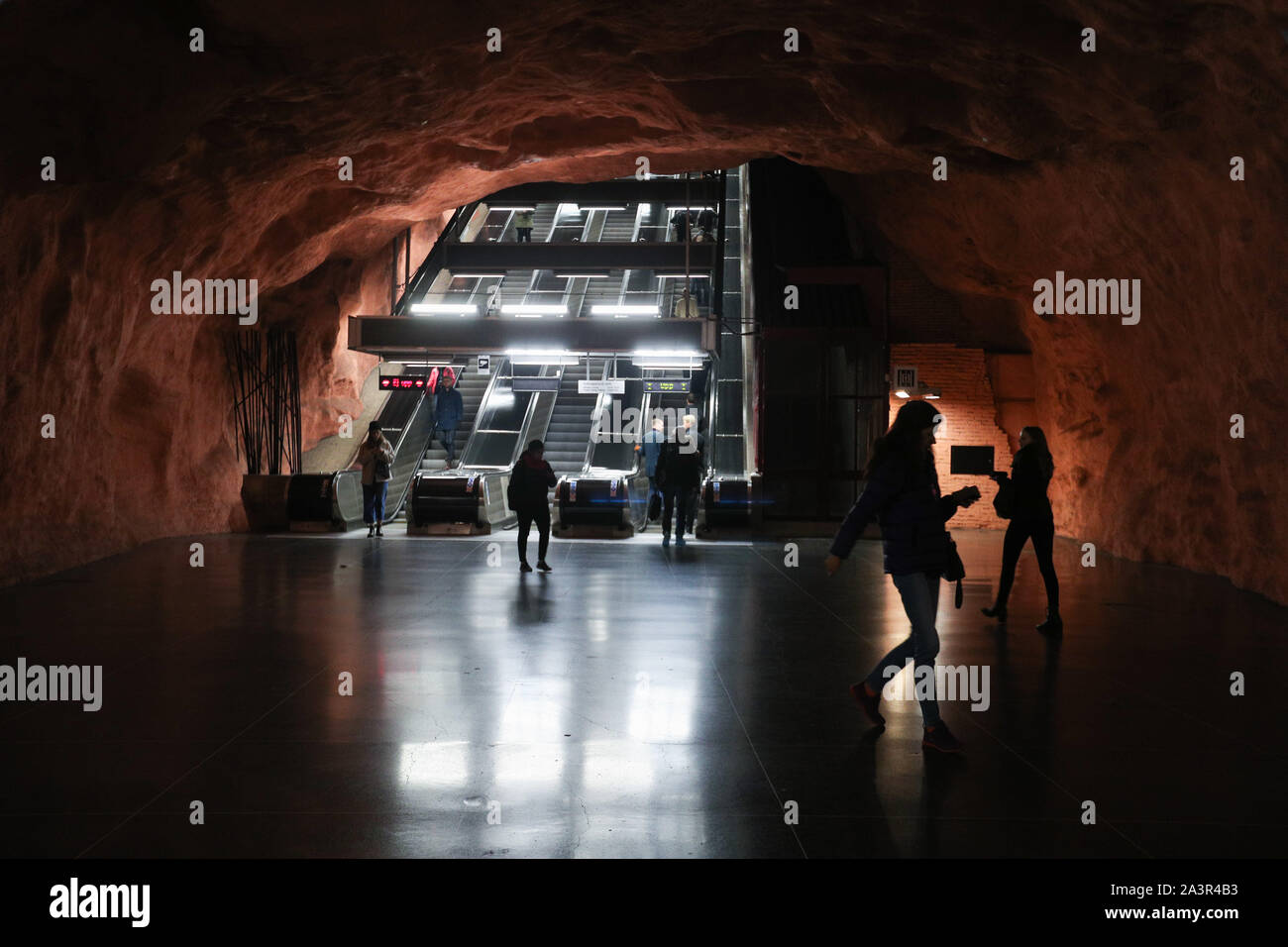 Stockholm, Sweden. 8th Oct, 2019. Passengers walk in the Radhuset metro station in Stockholm, Sweden, Oct. 8, 2019. Till now, Stockholm's subway system consists of one hundred stations, each with unique art on its platform, walls or waiting hall. Since 1957, artists have been greatly involved in the building of new stations, and they also added beautiful statues, murals, and installations to the older stations. Credit: Zheng Huansong/Xinhua/Alamy Live News Stock Photo