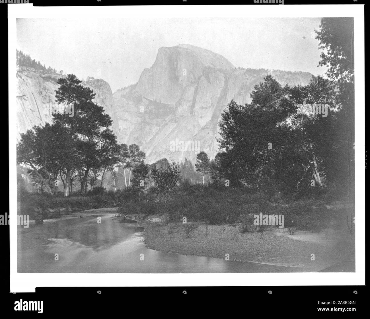 Stream with trees and mountains in background, Yosemite National Park, Calif. Stock Photo