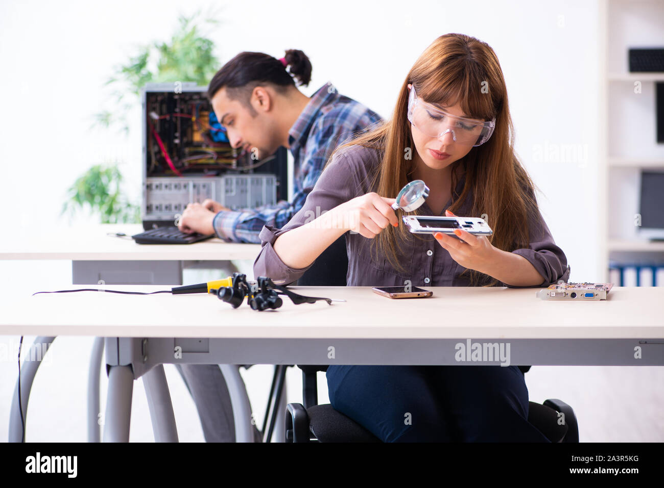 The two technicians working at computer warranty center Stock Photo