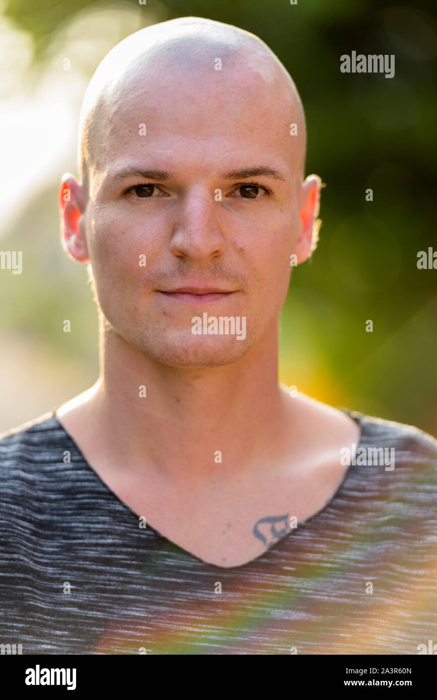 Face of young handsome bald man outdoors Stock Photo