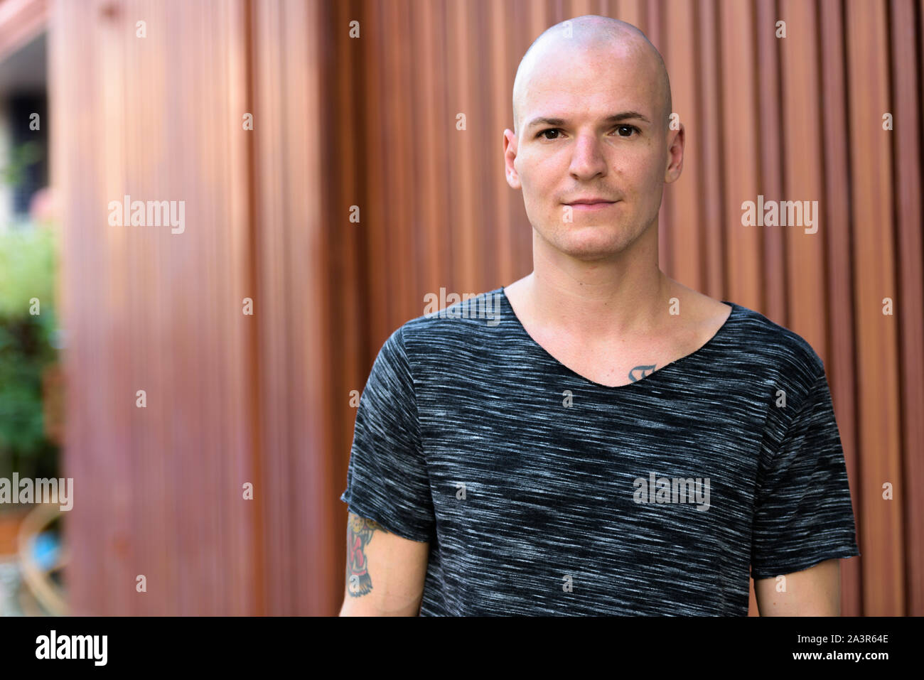 Portrait of young handsome bald man outdoors Stock Photo