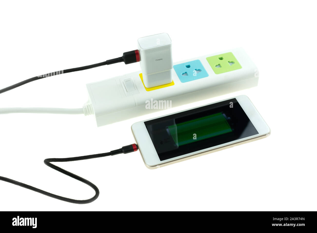 Adapter smart phone charger at plug in power outlet at white background