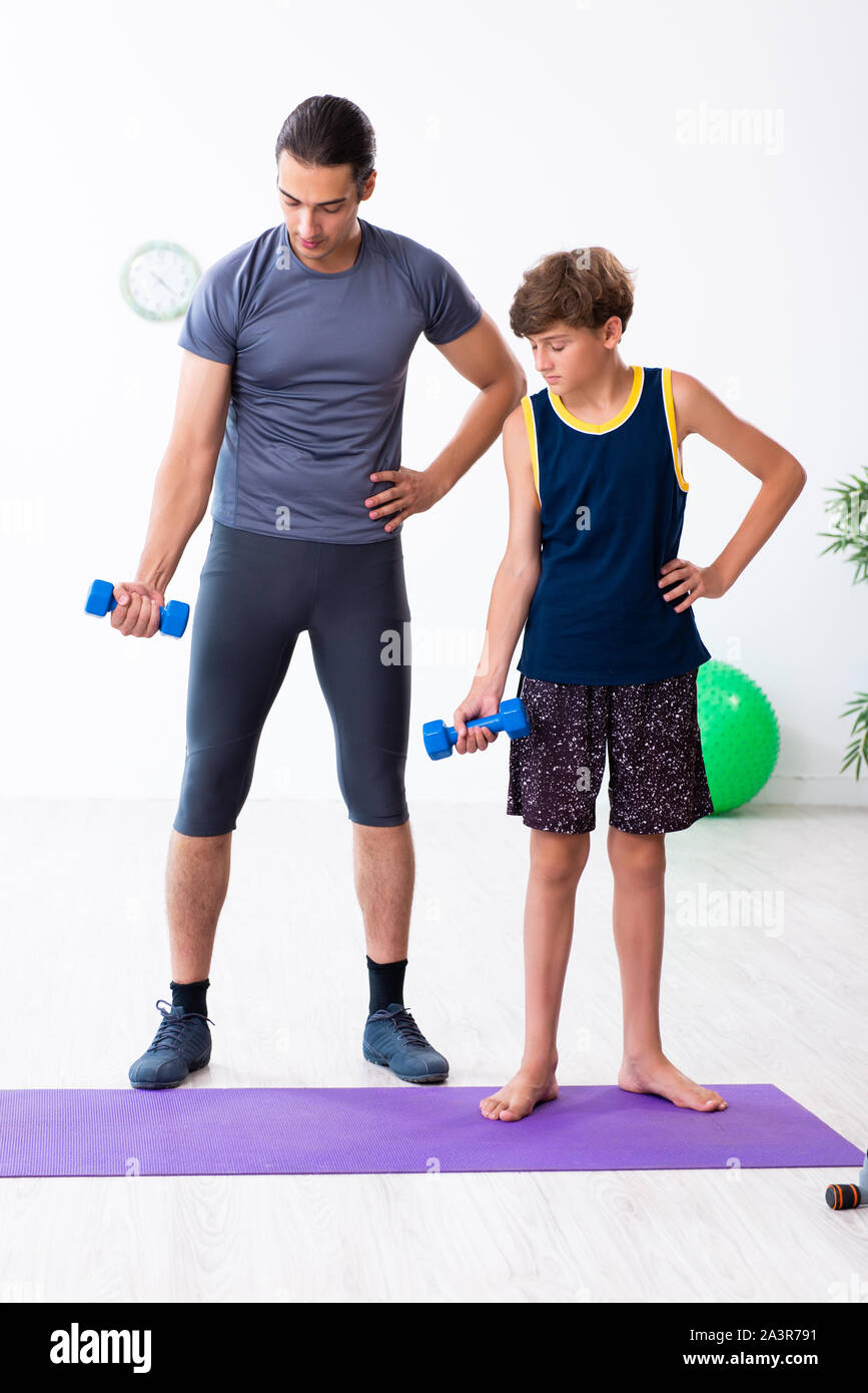 The young father and his son doing exercises Stock Photo - Alamy