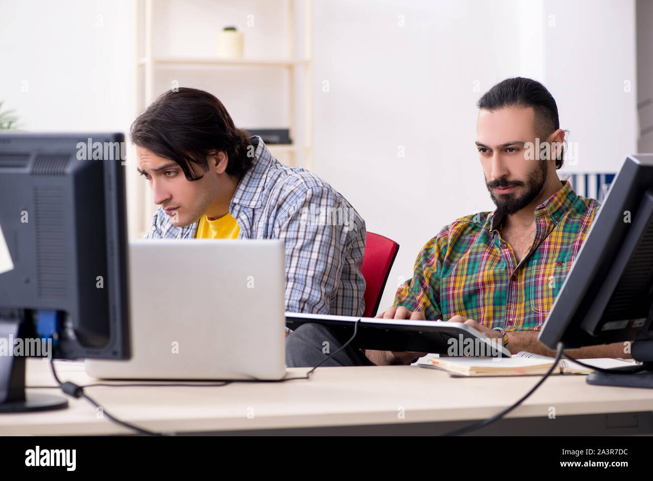 The two it specialists working in the office Stock Photo