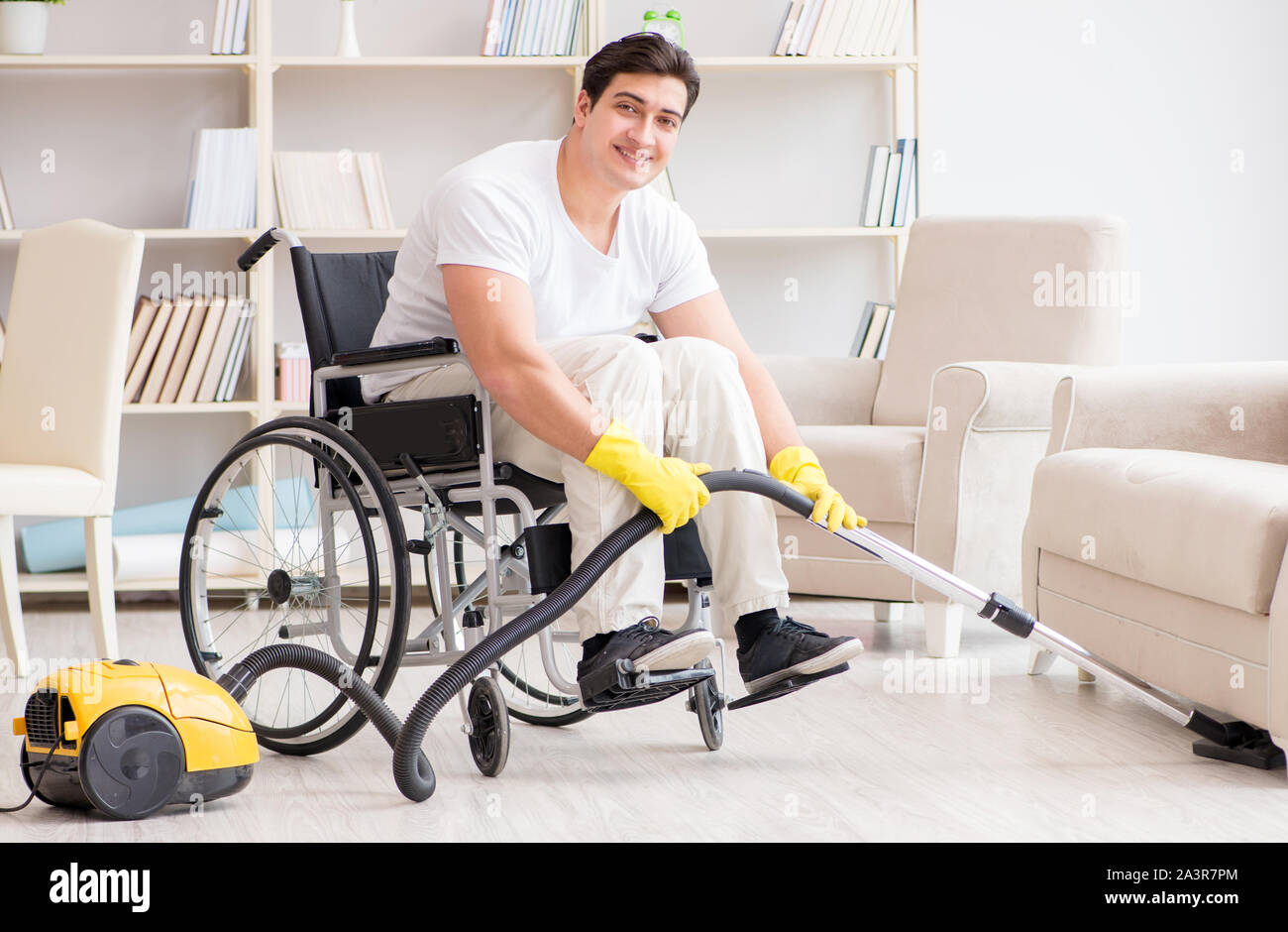 The disabled man with vacuum cleaner at home Stock Photo Alamy