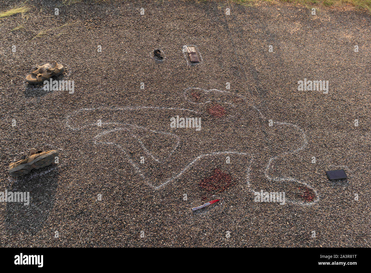 Crime scene chalk outline of victim dead body on Road with blood and evidences, Concept of murder investigation Stock Photo