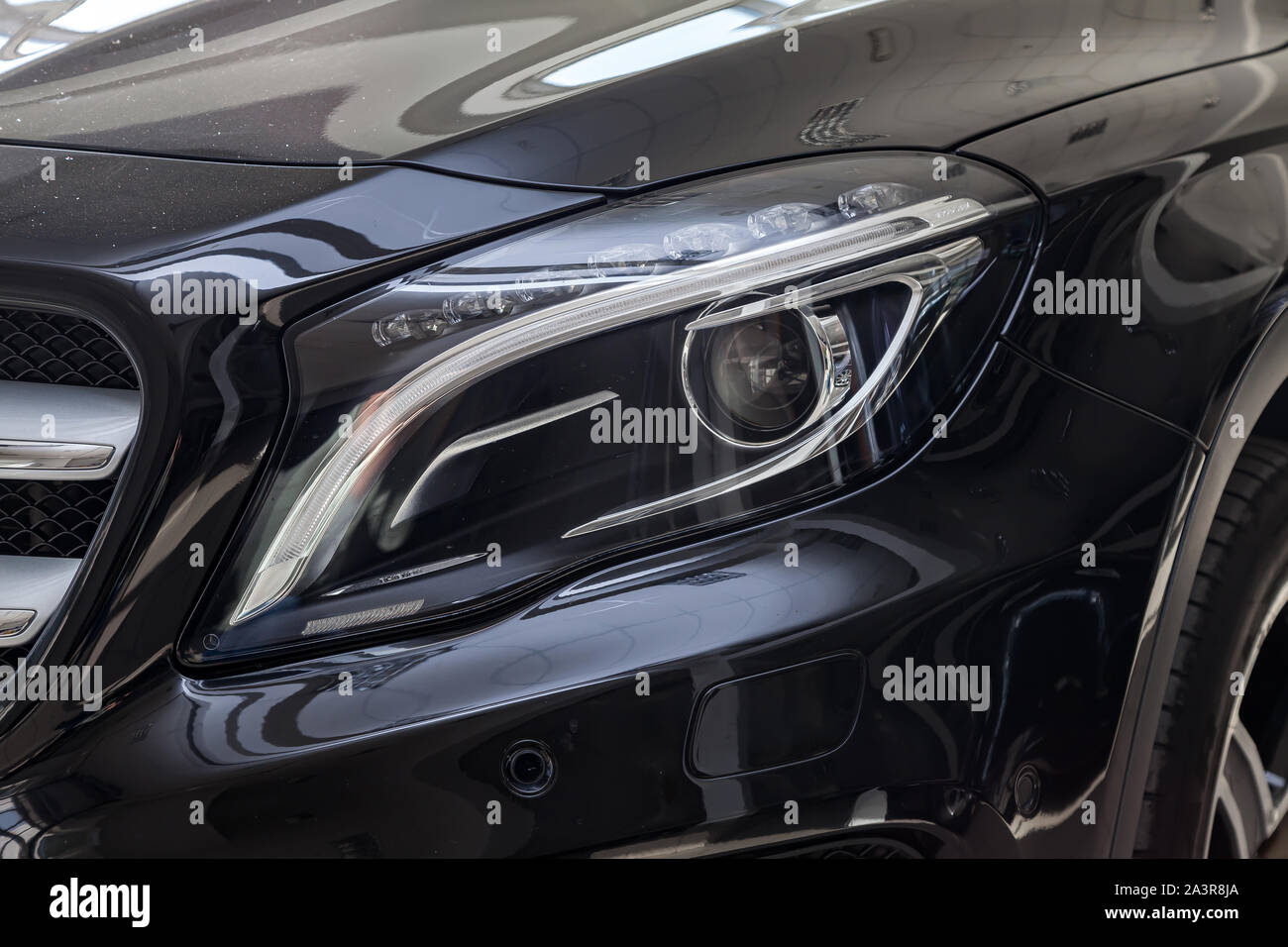 Novosibirsk, Russia - 08.01.2018: Black Mercedes Benz Gla class 2016 year front headlight view with dark gray interior in excellent condition in a dea Stock Photo
