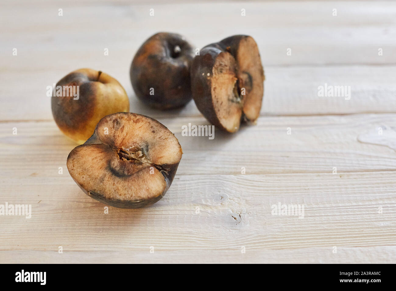 rotten sliced apple on a wooden surface Stock Photo