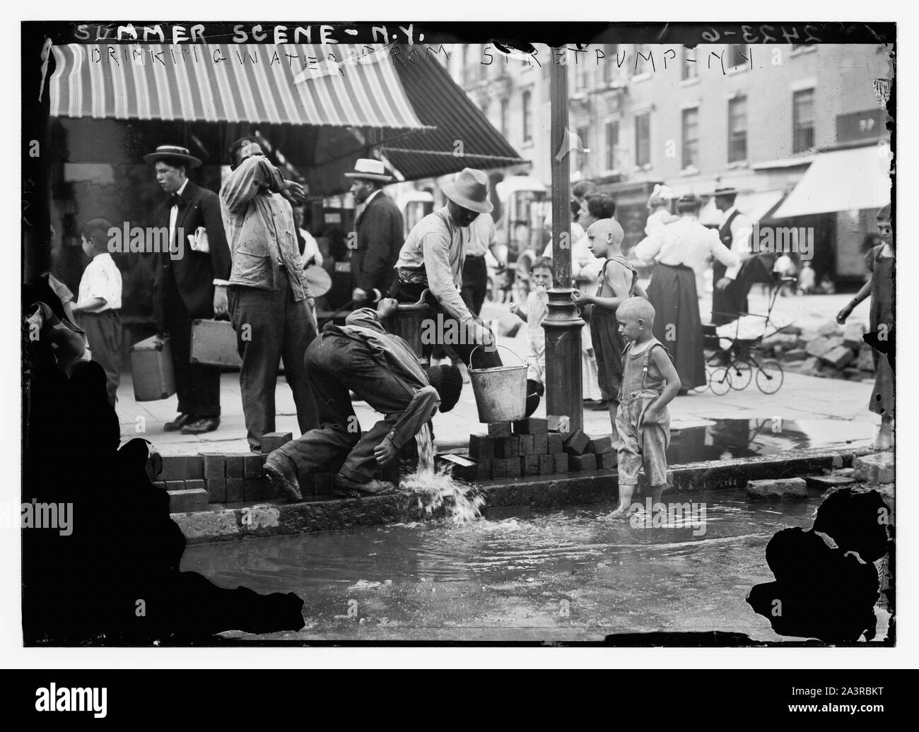 Summer scene, N.Y. - drinking water from street pump Stock Photo