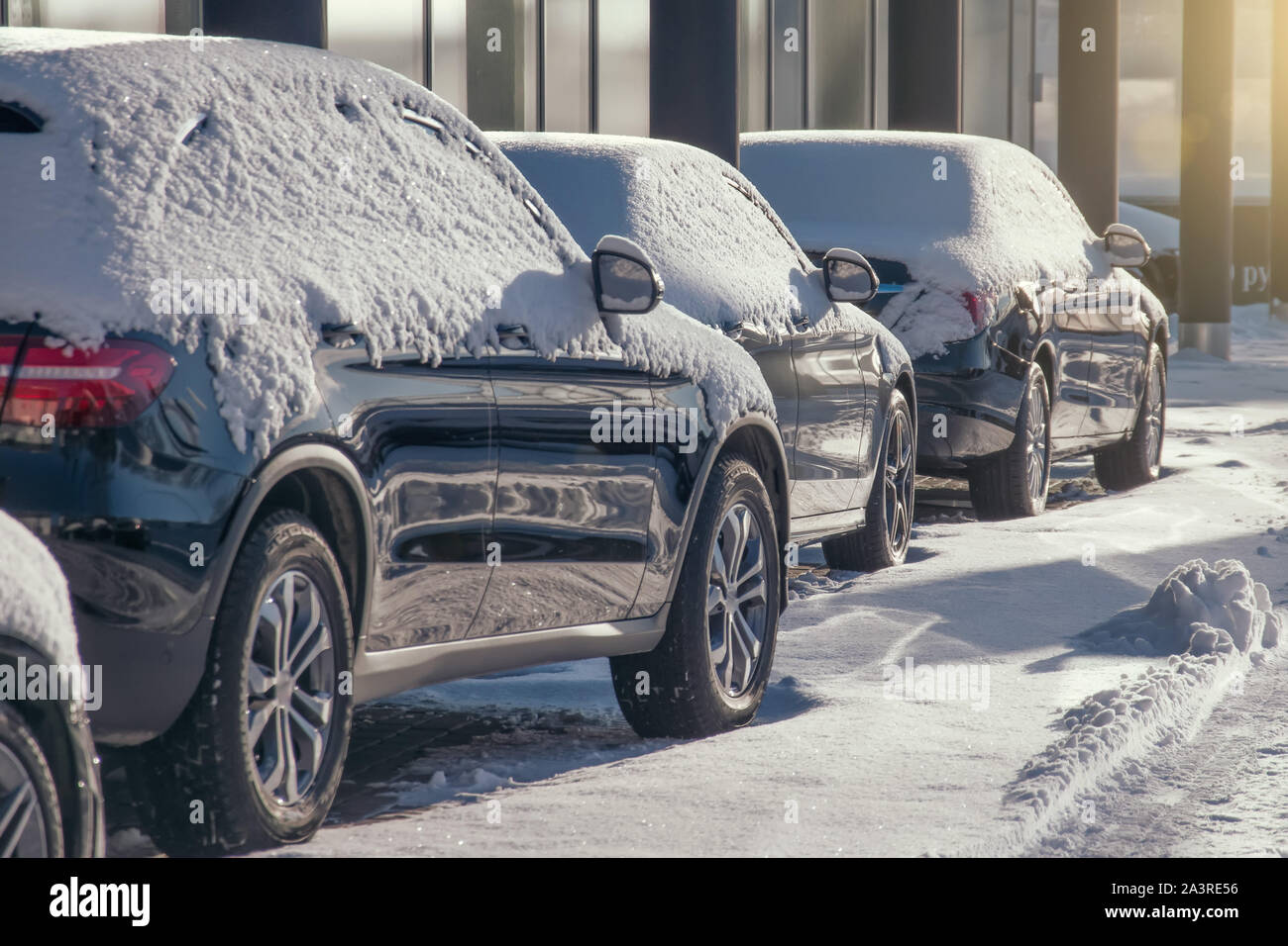 Parking lot with cars sunlit covered in fresh snow Stock Photo - Alamy