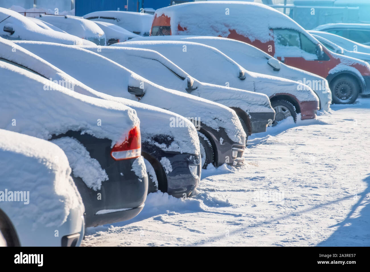 Parking lot with cars sunlit covered in fresh snow Stock Photo - Alamy