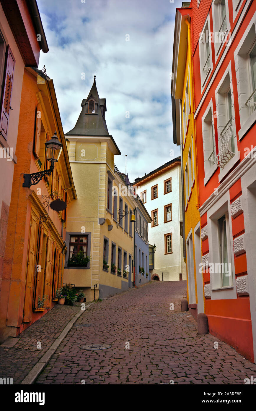 Romantic cobblestone alley with colorful houses in the old town of