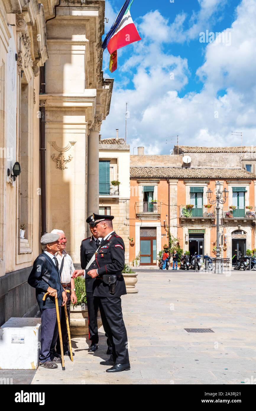 Syracuse Sicily/ Italy - october 04 2019: Carabinieri discuss with two elderly people in the town square Stock Photo