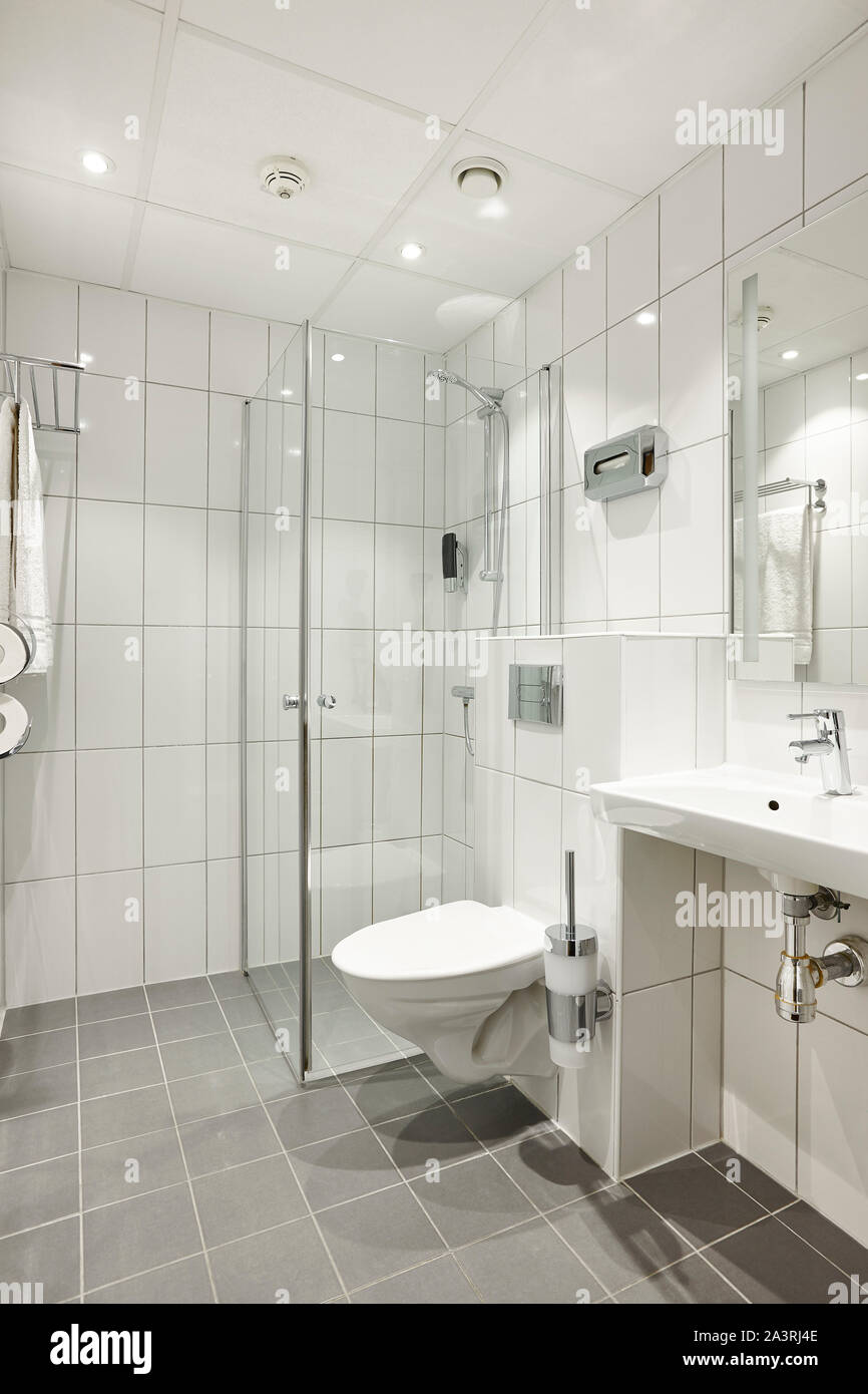 Modern clean bathroom design interior in white color tiles. Vertical ...