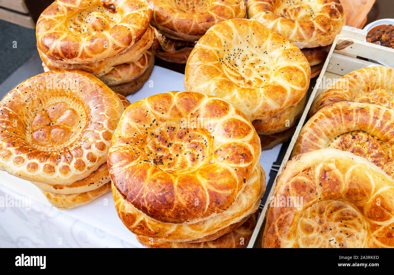 Appetizing uzbek flatbreads with sesame seeds from the tandir. Traditional eastern flat cakes Stock Photo