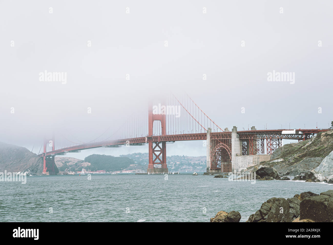 View of Golden Gate Bridge in the fog from the near beach Stock Photo