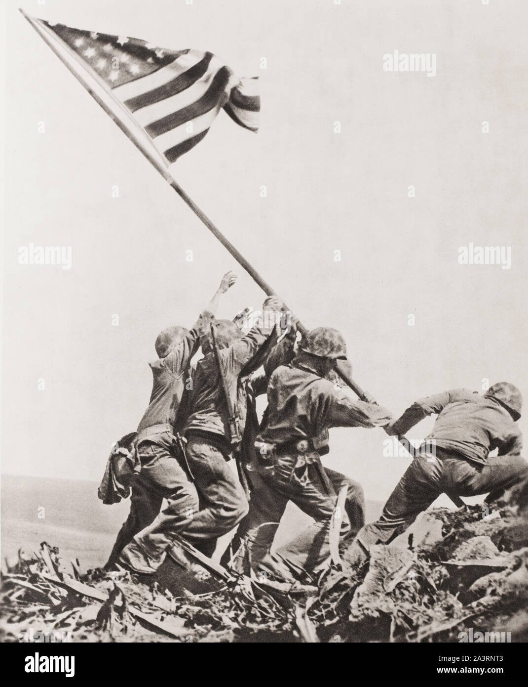 The defeat of Japanese imperialism. The American flag is raised at Mount Suribachi, Iwojima island. From now on, the American Air Force has three airf Stock Photo