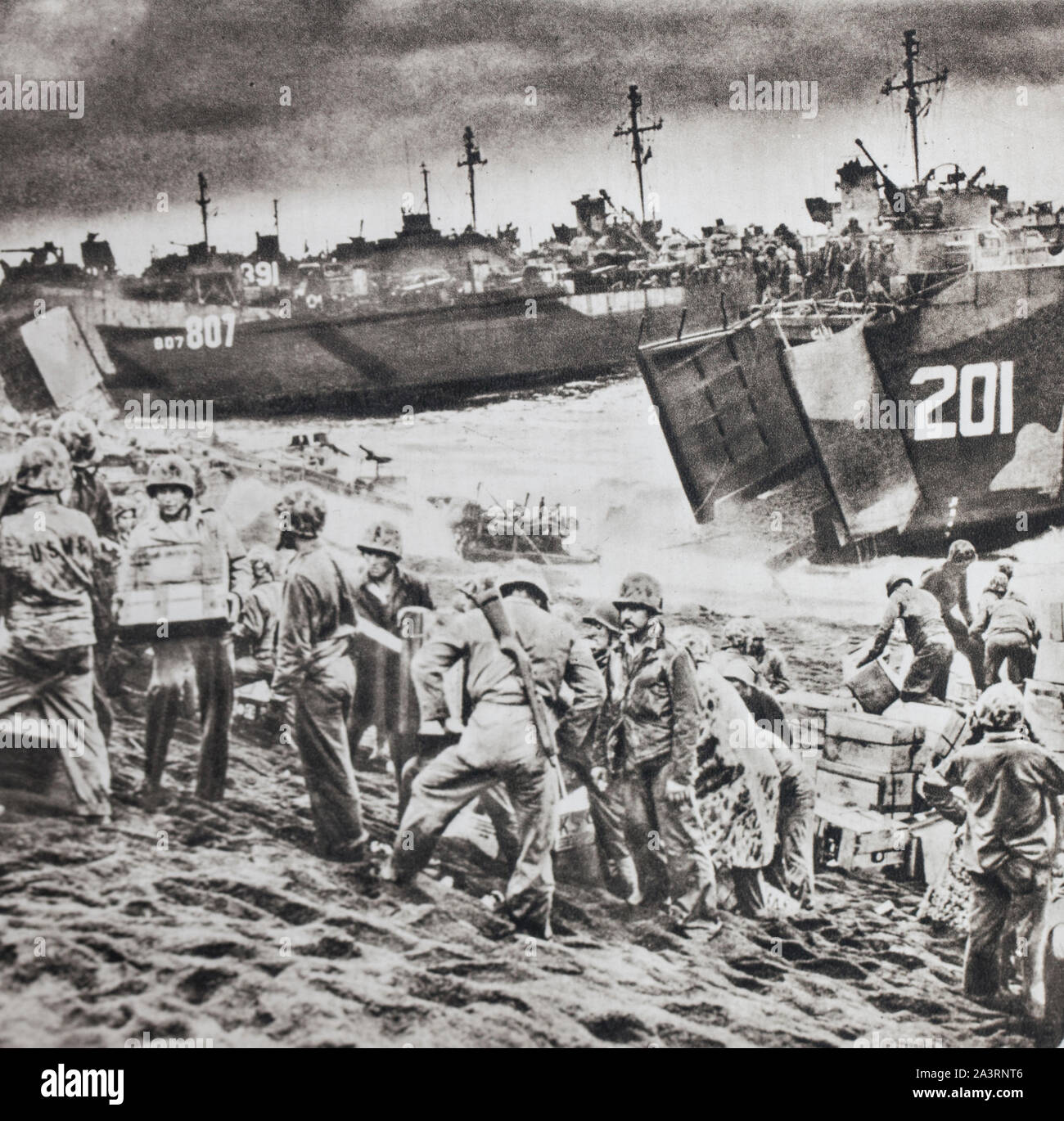 The American equipment debarque in Iwo Jima island. An unbroken flow of troops and equipment is poured onto the beaches of this hard-to-reach vocanic Stock Photo