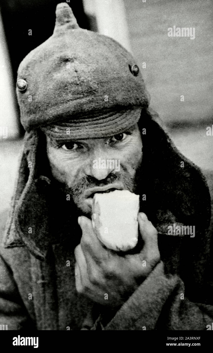 Photo of soviet war prisoner wiht piece of bread. The Winter War. 1939 Stock Photo