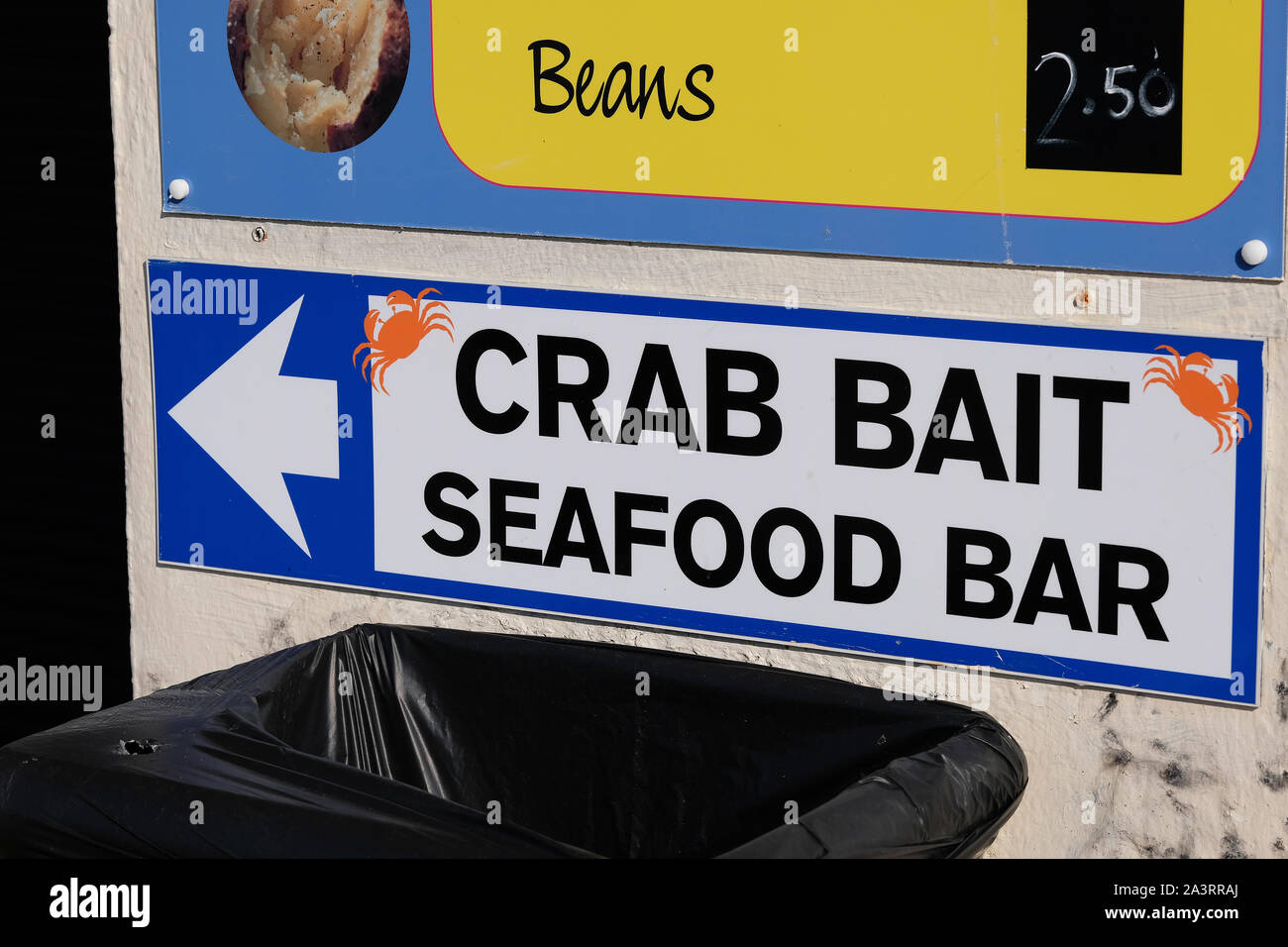 Crab food and seafood bar on same sign. Stock Photo