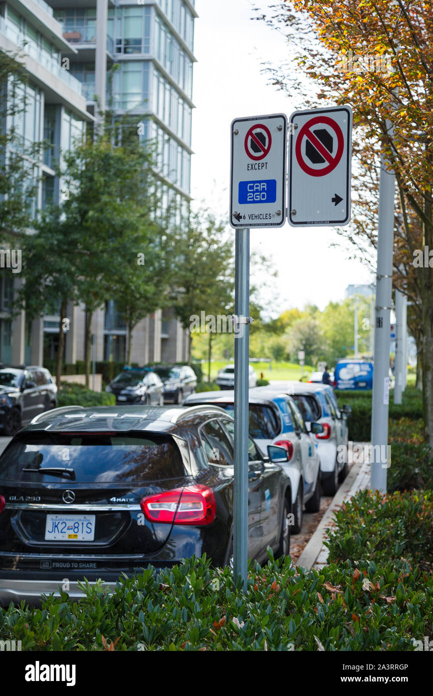 VANCOUVER, BC, CANADA - SEPT 21, 2019: A row of Car2Go SmartCars in Vancouver's Olympic Village which make up part of Vancouver's ridesharing car Stock Photo