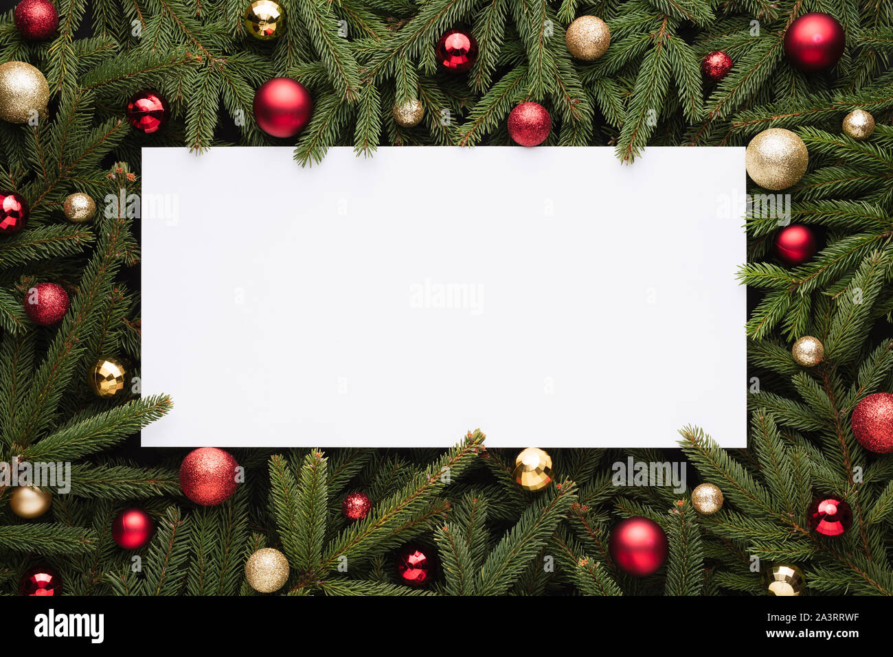 Christmas or New Year decoration background with copy space. Festive frame of fir branches and Christmas balls Stock Photo