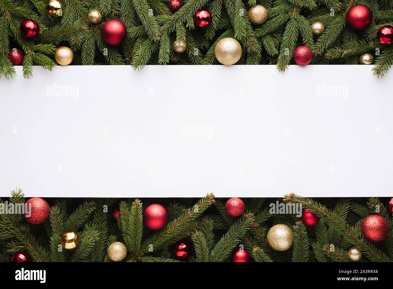 Christmas or New Year decoration background with copy space. Festive border of fir branches and Christmas balls Stock Photo