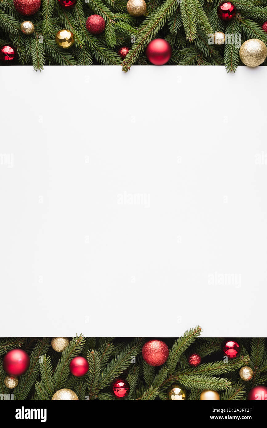 Merry Christmas and Happy Holidays decoration background. Fir branches and Christmas balls border Stock Photo