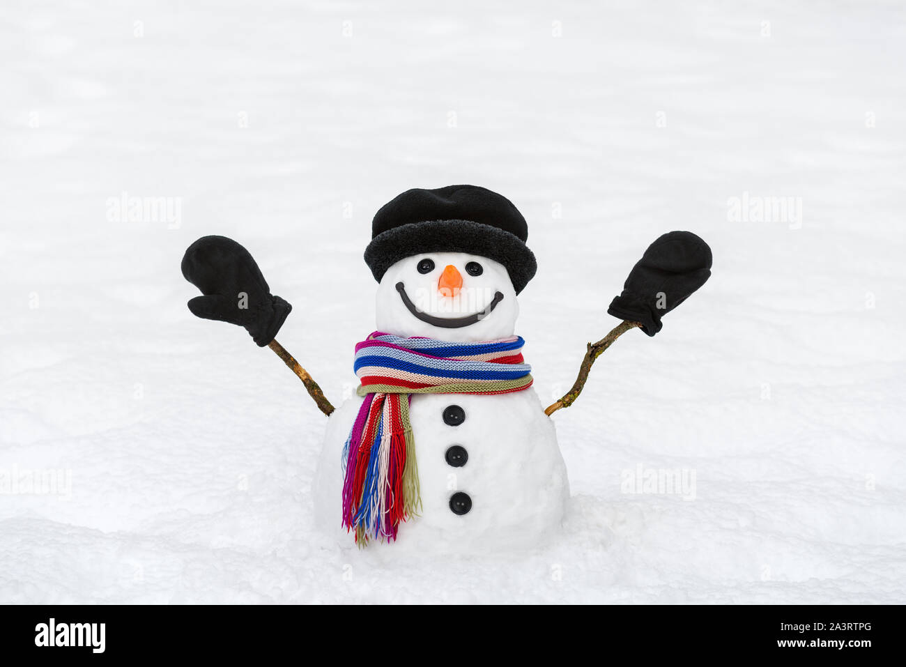 Cheerful snowman with mittens. New Year and Christmas card with a traditional winter character Stock Photo