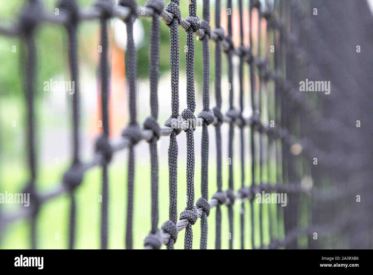 Close-up of grey gray mesh net around football soccer field Stock Photo