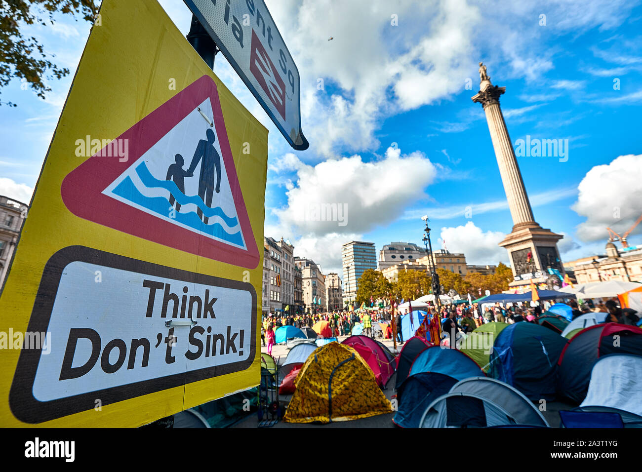 London, U.K. - Oct 9, 2019: A protest sign in Trafalgar Square next to tents belonging to environmental campaigners from Extinction Rebellion on the third day of a planned two weeks of protests. Stock Photo