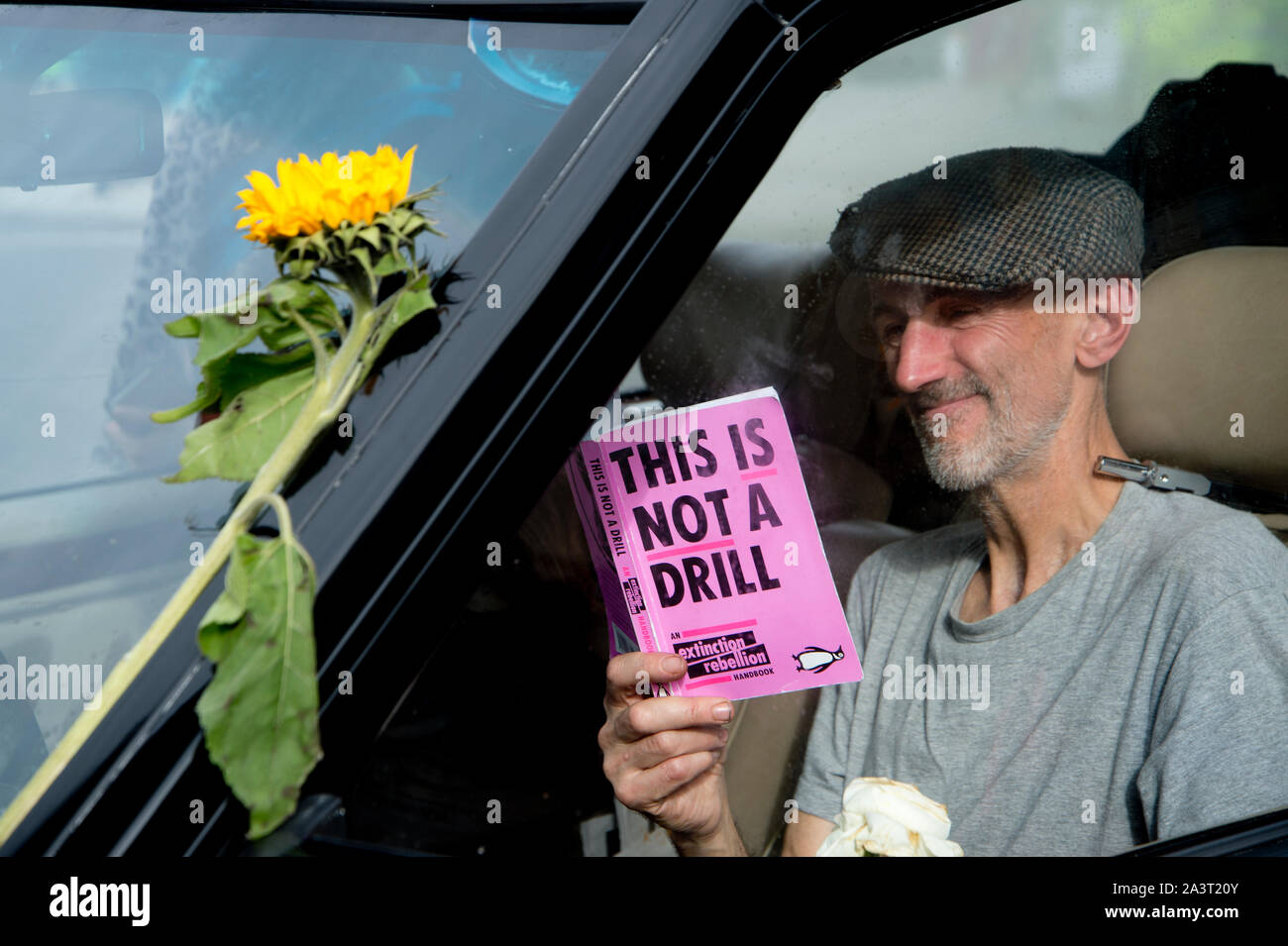 Extinction Rebellion, Central London, October 8th 2019. The hearse blocking the road at Trafalgar Square. A protester reads 'This is not a drill'. Stock Photo