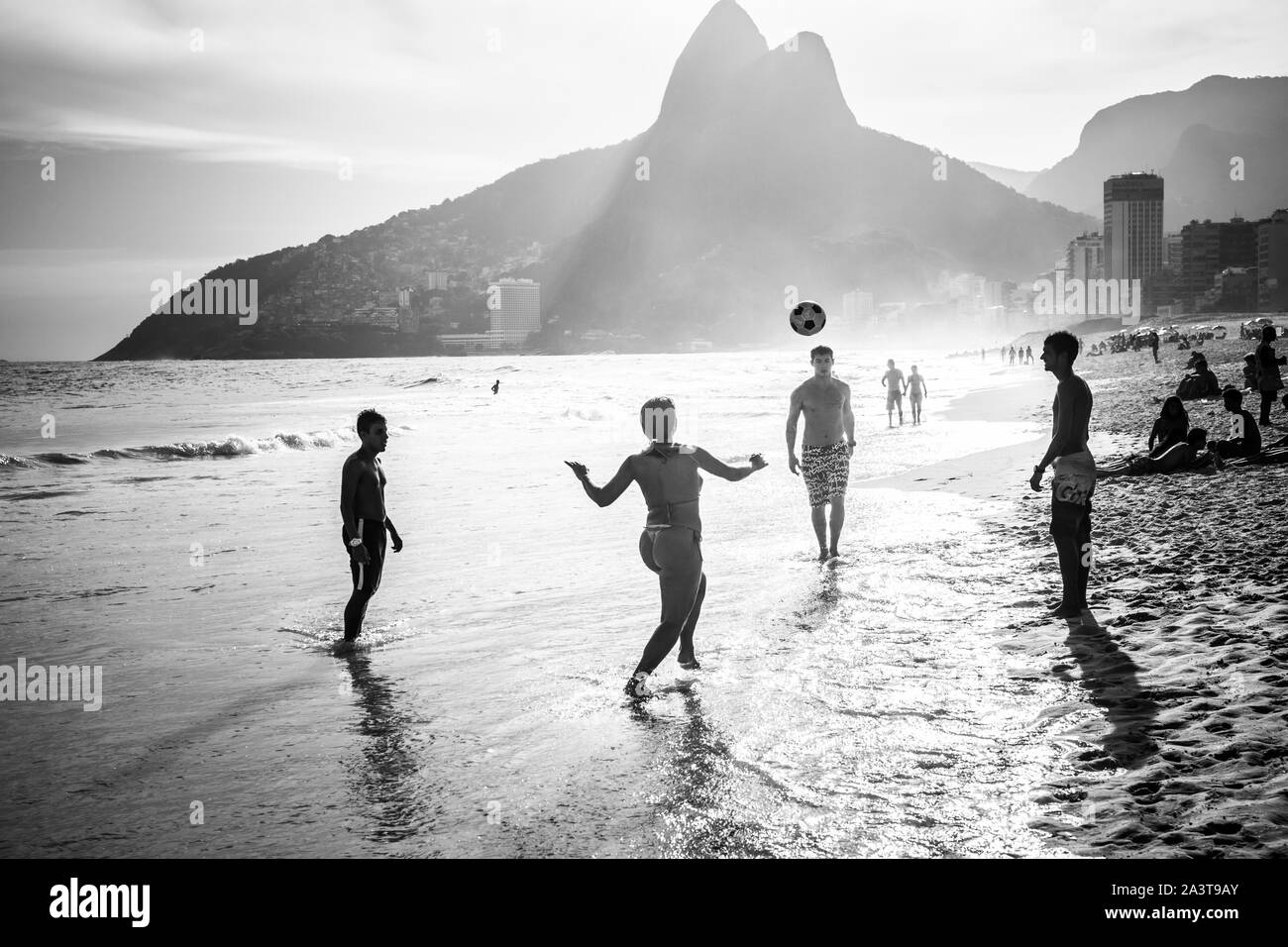 A group of Brazilians playing on the shore of Ipanema Beach Stock Photo