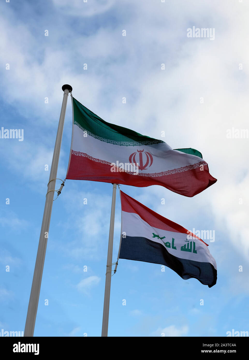 National flags of Iran and Iraq waving in the wind Stock Photo