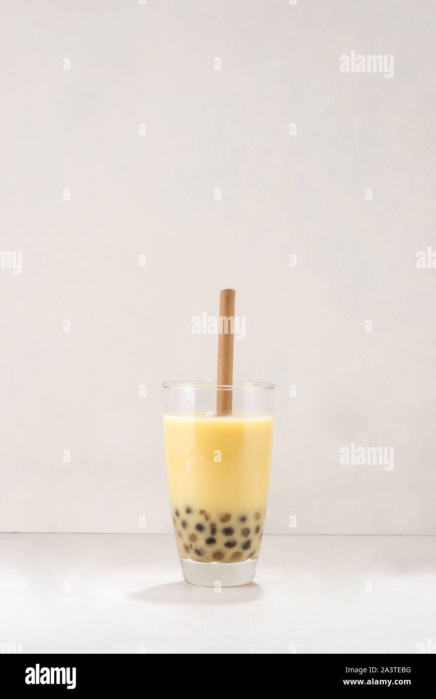 Bubble boba tea with milk and tapioca pearls in glass on white ...