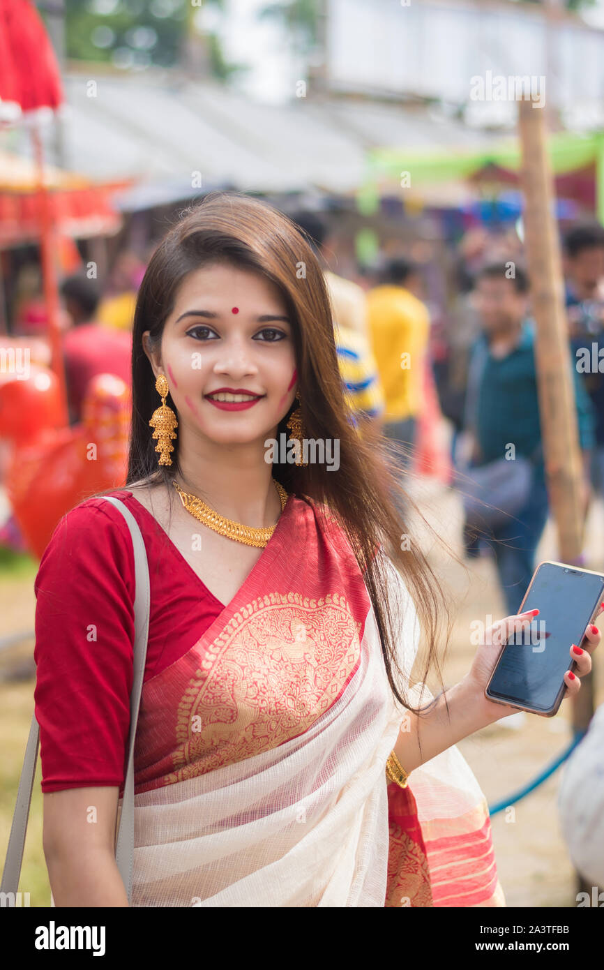 Kolkata, India – 8th October 2019; Women participate in Sindur Khela at a puja pandal on the last day of Durga puja at Baghbazar Sarbojanin in Kolkata Stock Photo