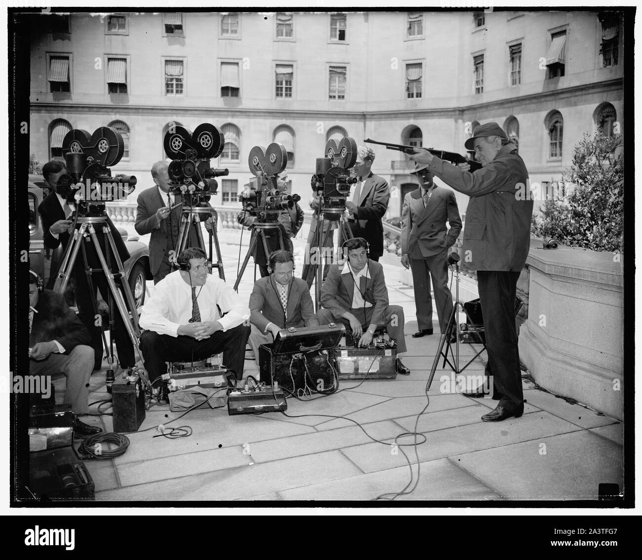 Texas senator tries out shooting irons for news cameramen. Washington, D.C., June 14. Looking forward to a hunting trip in his native state as soon as Congress adjourns this week, Senator Tom Connally, democrat of Texas, checked his guns and did a little fancy shooting for the benefit of the cameramen at the Capitol today, 6/14/38 Stock Photo